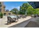 Community pool deck with dining tables, lounge chairs, and barbecue grills at 905 Juniper Ne St # 805, Atlanta, GA 30309