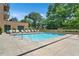 Beautiful community pool surrounded by lounge chairs and lush landscaping at 905 Juniper Ne St # 805, Atlanta, GA 30309