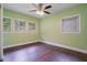 Bedroom showcases hardwood floors, vibrant green walls, and multiple windows for natural light at 2049 Rector Dr, Atlanta, GA 30311