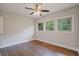 Bedroom features hardwood floors, neutral walls, and three windows with green views at 2049 Rector Dr, Atlanta, GA 30311