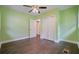 Bedroom showcases hardwood floors, vibrant green walls, and access to closet and bathroom at 2049 Rector Dr, Atlanta, GA 30311