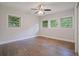 Bedroom showcasing hardwood floors, neutral walls, and three large windows for ample natural light at 2049 Rector Dr, Atlanta, GA 30311