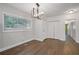 Inviting dining room features hardwood floors, closet space, a modern chandelier, and a large window at 2049 Rector Dr, Atlanta, GA 30311