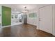 Dining area adjacent to a modern kitchen features hardwood floors and natural light from a large window at 2049 Rector Dr, Atlanta, GA 30311