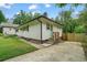 An inviting home featuring a well-kept lawn, a modern green door, an upgraded driveway, and wooden stairs at 2049 Rector Dr, Atlanta, GA 30311