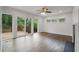 Spacious living room boasting hardwood floors, a ceiling fan, and sliding doors to a deck at 2049 Rector Dr, Atlanta, GA 30311