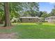 A sprawling lawn and brick facade create an inviting backyard space at 2483 Hunting Valley Dr, Decatur, GA 30033
