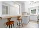 Modern kitchen with breakfast bar seating, white cabinets, and stainless steel appliances at 2483 Hunting Valley Dr, Decatur, GA 30033