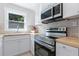 Bright kitchen features white cabinets, stainless steel appliances, and a butcher block countertop at 2483 Hunting Valley Dr, Decatur, GA 30033