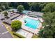 Aerial view of a community pool and tennis courts surrounded by lush greenery and trees at 2658 Briarlake Ne Rd, Atlanta, GA 30345