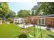 Lush backyard featuring beautiful patio, seating, and fun swings at 2658 Briarlake Ne Rd, Atlanta, GA 30345