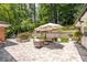 Manicured backyard featuring beautiful stone patio with seating, and mature landscaping at 2658 Briarlake Ne Rd, Atlanta, GA 30345
