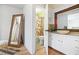An open bathroom with an elegant stone sink, white cabinetry, and unique orange and green shower curtain at 2658 Briarlake Ne Rd, Atlanta, GA 30345