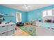 Playful bedroom with bright blue walls, hardwood floors, a cozy blue chair, and lots of toy storage at 2658 Briarlake Ne Rd, Atlanta, GA 30345
