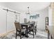Dining room featuring modern lighting and barn door access to the kitchen at 2658 Briarlake Ne Rd, Atlanta, GA 30345