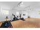 Spacious home gym featuring a full suite of modern exercise equipment and track lighting at 2658 Briarlake Ne Rd, Atlanta, GA 30345