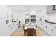 Modern white kitchen featuring updated appliances and cabinetry, and a eat-in table at 2658 Briarlake Ne Rd, Atlanta, GA 30345