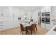 Bright eat-in kitchen with white cabinetry, stainless steel appliances, and stylish breakfast table at 2658 Briarlake Ne Rd, Atlanta, GA 30345