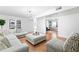 Spacious living room with comfortable seating, neutral-toned furniture, french doors, and modern lighting at 2658 Briarlake Ne Rd, Atlanta, GA 30345