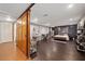 Open bedroom design featuring a sliding barn door, desk area, and wood-look flooring at 3048 Briarcliff Ne Rd # 9, Atlanta, GA 30329
