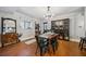 Spacious dining room with hardwood floors, a modern light fixture, and a built-in bar and pantry cabinet at 3048 Briarcliff Ne Rd # 9, Atlanta, GA 30329