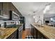Kitchen with granite countertops, stainless steel appliances, and dark cabinetry, featuring open access to other rooms at 3048 Briarcliff Ne Rd # 9, Atlanta, GA 30329
