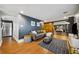 Inviting living room featuring a sectional sofa, stylish accents, and warm-toned wood-look flooring at 3048 Briarcliff Ne Rd # 9, Atlanta, GA 30329