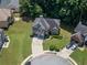 Beautiful two-story home featuring a stone facade, well-manicured lawn, and circular driveway in a suburban setting at 3310 Mcclure Woods Ct, Duluth, GA 30096