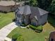 Well-manicured two-story home with a large driveway and mature trees at 3310 Mcclure Woods Ct, Duluth, GA 30096