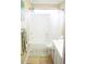 Bathroom featuring a tub with shower and white fixtures at 3310 Mcclure Woods Ct, Duluth, GA 30096