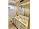 Bathroom featuring a double vanity and a large mirror reflecting the shower over the tub at 3310 Mcclure Woods Ct, Duluth, GA 30096