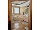 Bathroom featuring tub, tiled floors, and cabinets at 3310 Mcclure Woods Ct, Duluth, GA 30096