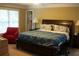 This is a primary bedroom with a decorative tray ceiling, windows, an accent chair and an en-suite bathroom at 3310 Mcclure Woods Ct, Duluth, GA 30096