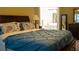 Comfortable bedroom featuring a cozy bed with stylish blue comforter and patterned pillows at 3310 Mcclure Woods Ct, Duluth, GA 30096