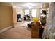 Bright bedroom featuring neutral colored walls, carpet floors, desk, two windows, and white trim at 3310 Mcclure Woods Ct, Duluth, GA 30096