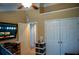 Bedroom features double closets, a ceiling fan, and a wall-mounted television at 3310 Mcclure Woods Ct, Duluth, GA 30096