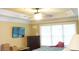 Bright bedroom features crown molding, a ceiling fan, and a TV mounted on the wall at 3310 Mcclure Woods Ct, Duluth, GA 30096