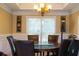 Dining room features round glass table, six chairs, and decorative wall shelves at 3310 Mcclure Woods Ct, Duluth, GA 30096