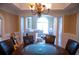 Elegant dining room with stylish chandelier, wainscoting, and arched doorway at 3310 Mcclure Woods Ct, Duluth, GA 30096