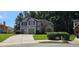Beautiful home featuring a 2-car garage, well-manicured lawn, and mature trees at 3310 Mcclure Woods Ct, Duluth, GA 30096