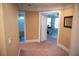 Hallway with views into a bathroom and into another room with a ceiling fan and big window at 3310 Mcclure Woods Ct, Duluth, GA 30096