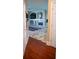 Hallway showcasing tile and hardwood flooring, leading to the living room at 3310 Mcclure Woods Ct, Duluth, GA 30096