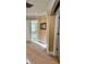 Hallway featuring tan walls and carpet with an open doorway leading to a brightly lit room at 3310 Mcclure Woods Ct, Duluth, GA 30096