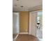 Hallway featuring carpeted floor with an open doorway that leads to a brightly lit room at 3310 Mcclure Woods Ct, Duluth, GA 30096