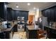 Well-equipped kitchen with black cabinets, granite countertops, and stainless steel appliances at 3310 Mcclure Woods Ct, Duluth, GA 30096