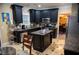 Eat-in kitchen with granite counters, black cabinetry, stainless steel appliances, and island at 3310 Mcclure Woods Ct, Duluth, GA 30096