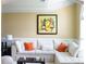 Bright living room features a large white sofa with orange throw pillows and modern artwork at 3310 Mcclure Woods Ct, Duluth, GA 30096