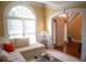 Inviting living room showcasing large arched windows, hardwood floors, and elegant trim at 3310 Mcclure Woods Ct, Duluth, GA 30096