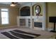 Bright living room with fireplace, built-in shelves, and large windows for natural light at 3310 Mcclure Woods Ct, Duluth, GA 30096