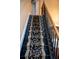 Stylish staircase with black railings and decorative carpet runner at 3310 Mcclure Woods Ct, Duluth, GA 30096